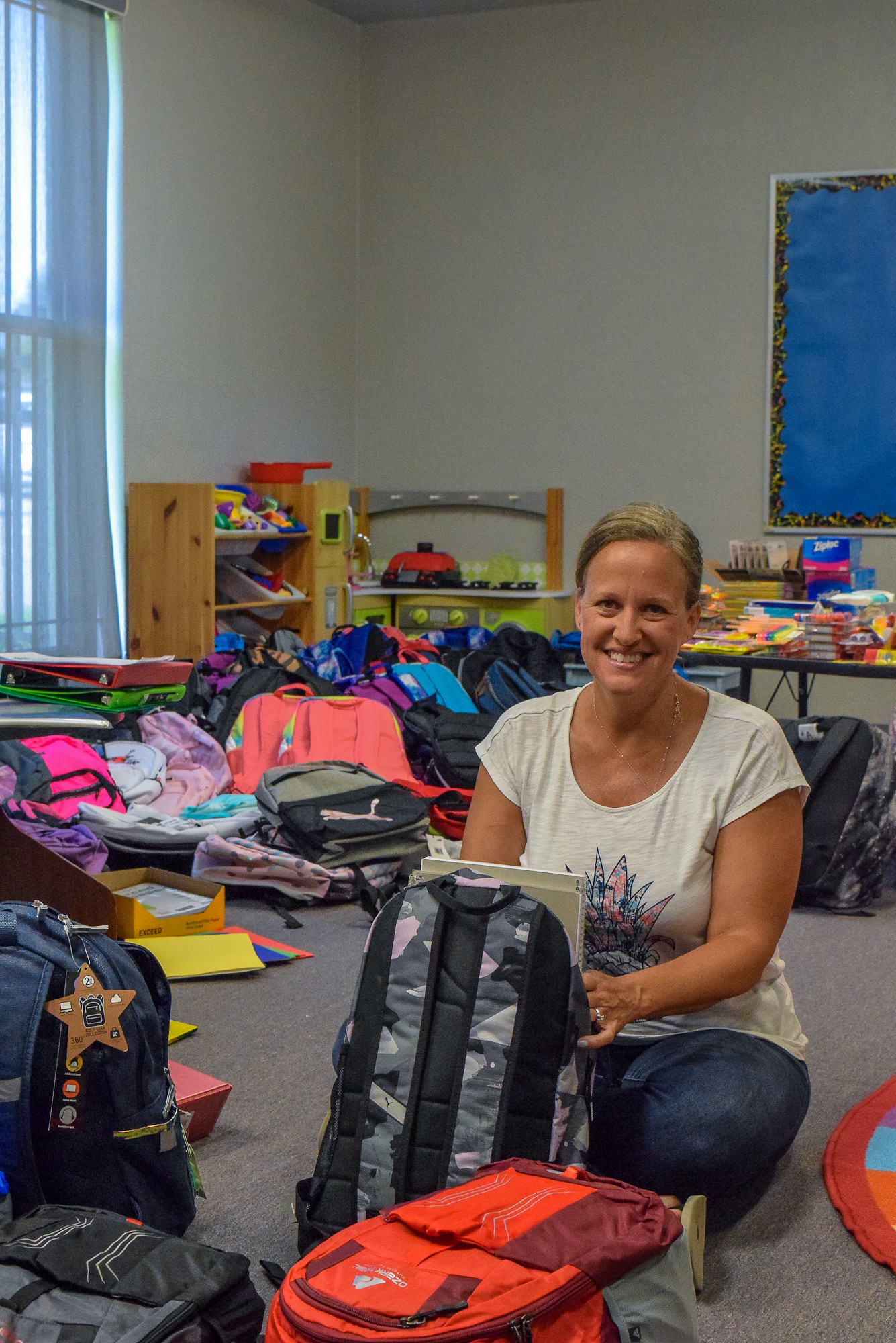 Volunteer Trisha McDonald sorting school supplies for backpacks